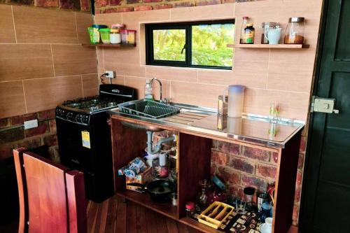 a small kitchen with a sink and a stove at Loft Industrial en Guateque, Boyacá in Guateque