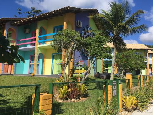 a colorful house with a fence in front of it at O Costão do Sol in Balneário Camboriú