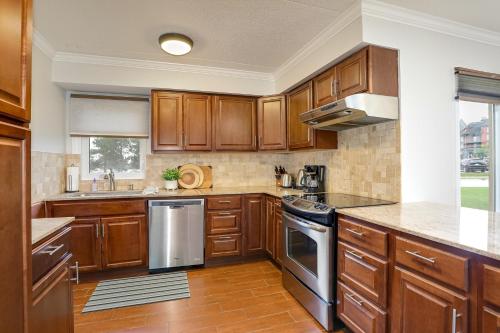 a kitchen with wooden cabinets and stainless steel appliances at Blue Mountain, 3 BR - 108 Mountain Walk Chalet in Blue Mountains