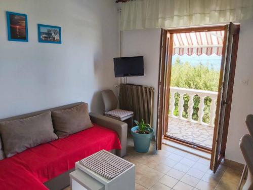 a living room with a couch and a large window at Petrcane house in Petrcane