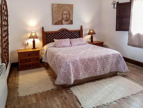 a bedroom with a bed with two night stands and two lamps at Villa for 4 with a private Pool & Garden in Bédar
