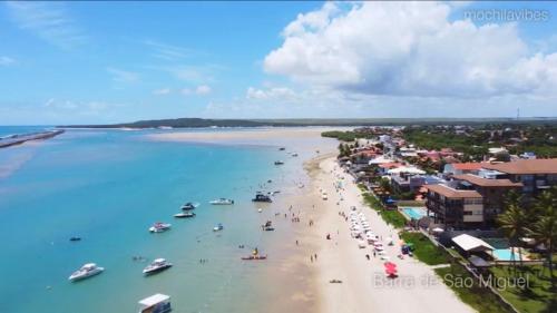 a view of a beach with boats in the water at Condomínio Barra Bali - apto 234 - Barra de São Miguel - Alagoas in Barra de São Miguel