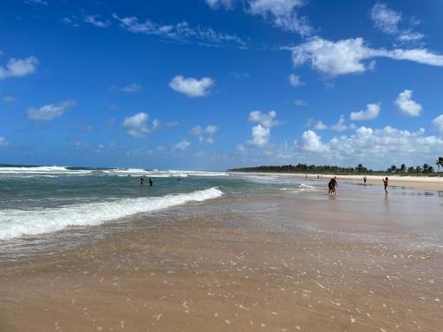 a group of people on a beach with the ocean at Condomínio Barra Bali - apto 234 - Barra de São Miguel - Alagoas in Barra de São Miguel