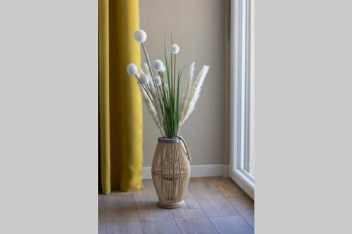 a vase filled with white flowers in a room at Maison Privilège Nature à La Petite Pierre in La Petite-Pierre
