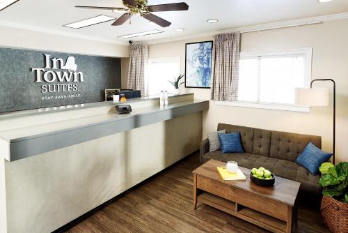 a lobby with a reception counter and a couch at InTown Suites Extended Stay Select Houston TX - BrookHollow in Houston