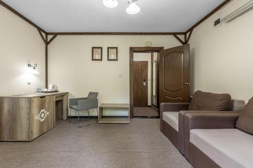 a living room with a couch and a table at Zahar Berkut in Slavske