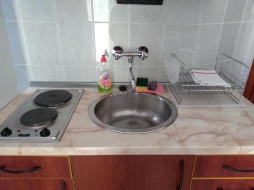 a kitchen counter with a sink and a stove at Apartment Stella in Murter