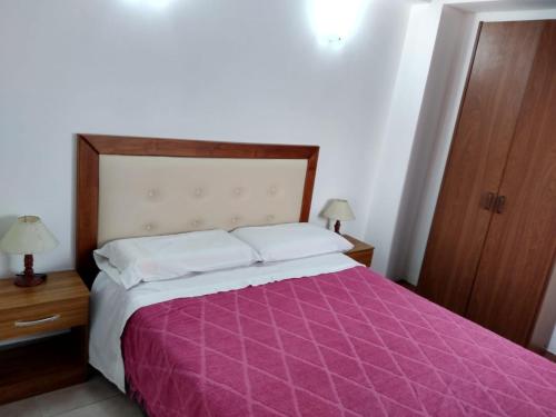 מיטה או מיטות בחדר ב-Brisas del Parque II