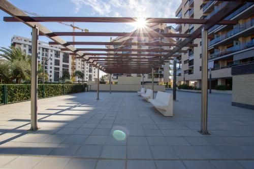 awning over a patio of a building with benches at APARTAMENTO ARENA en Playa de San Juan in Alicante