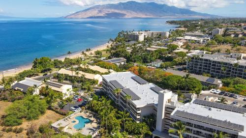 an aerial view of a beach and buildings and the ocean at Aston at the Maui Banyan in Wailea