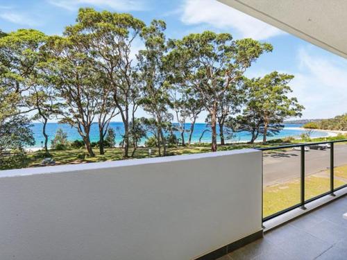 a balcony with a view of the ocean at 204 on the Beach by Experience Jervis Bay in Huskisson