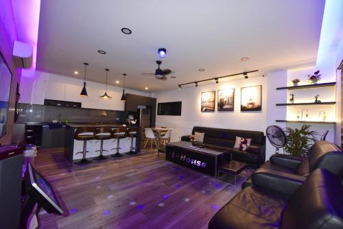 a living room with a couch and a bar at L-House時尚包棟會館 in Luodong