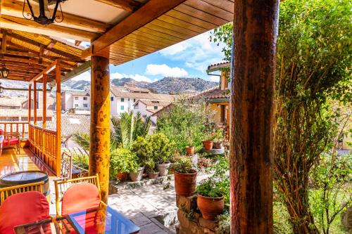 a patio with chairs and plants on a balcony at Amaru Inca in Cusco