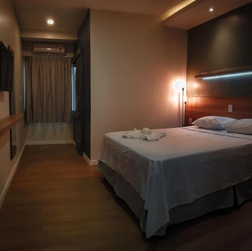 a hotel room with a large bed and a window at Blue Inn Hotel in Boa Vista