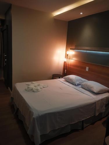 a bedroom with a bed with two towels on it at Blue Inn Hotel in Boa Vista