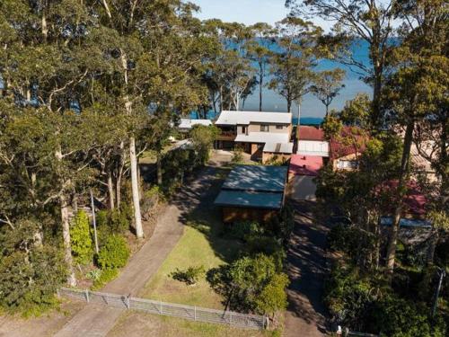 an aerial view of a house with a tennis court at Sea Eagle by Experience Jervis Bay in St Georges Basin