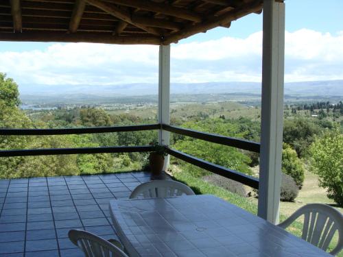 a table and chairs on a porch with a view at Vista del Condor in Villa Ciudad de America