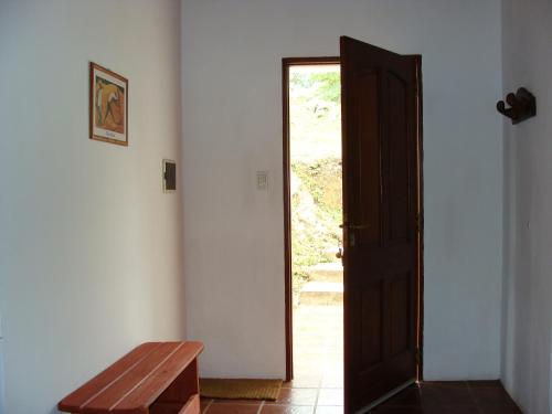 a room with a wooden table and a door at Vista del Condor in Villa Ciudad de America