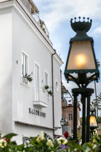a street light in front of a white building at Magi House Relais in Sorrento