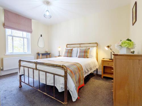 a bedroom with a large bed and a window at Four Priory Road, Chichester in Chichester