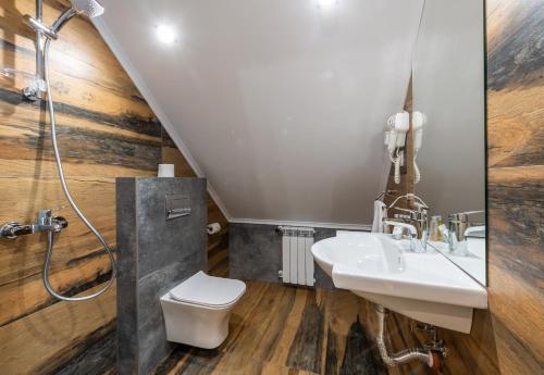 a bathroom with a sink and a toilet and a shower at Хотел Камъните in Burgas
