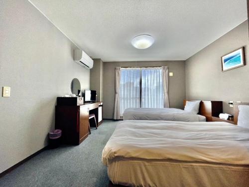 Postel nebo postele na pokoji v ubytování Hotel Umizola