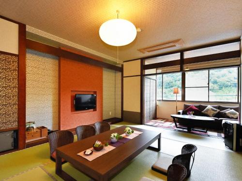 a living room with a table and a couch at Hamachiyokan in Ise