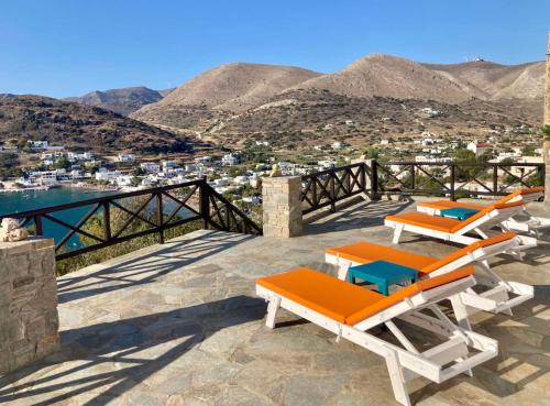 a patio with chairs and a view of a city at SYROU LOTOS Studios & Apartments in Kinion