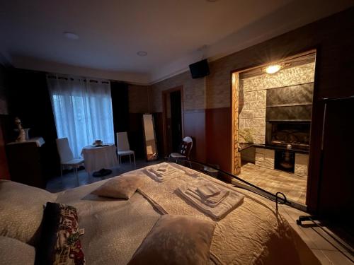 a bedroom with a large bed and a fireplace at Al cervo tra i laghi in Tavernerio