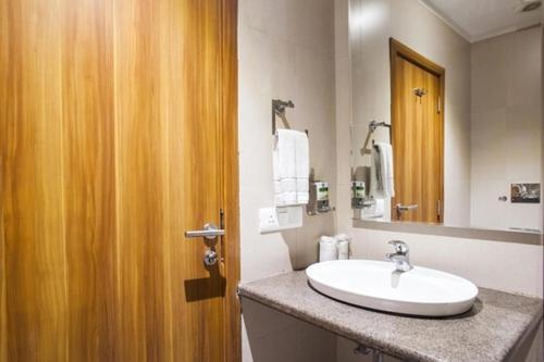 a bathroom with a sink and a mirror at Hotel Le Roi Raipur at Raipur Railway Station in Raipur