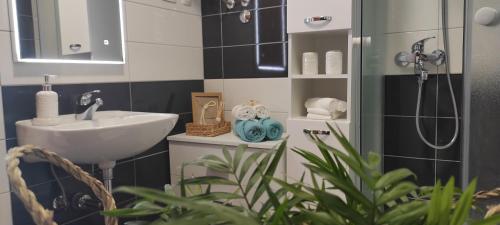 a bathroom with a sink and a shower at Holiday home Petra in Vinišće
