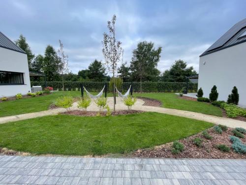 a garden with a hammock in a yard at Aqua Your Stay in Sasino