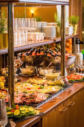 a buffet line with many different types of food at Berghotel Friedrichshöhe - Sauna, Pool & Natur in Kurort Altenberg