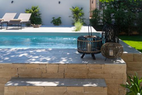 two trash cans sitting next to a swimming pool at Villa Villetta in Novigrad Istria