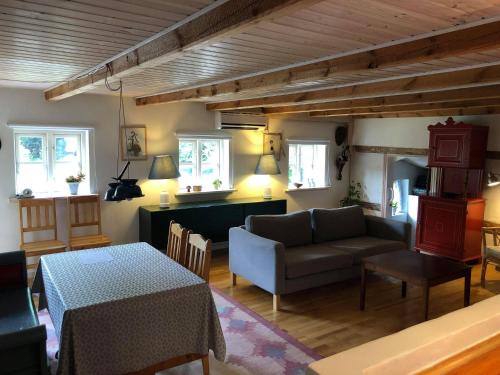 a living room with a couch and a table at Gæstehus Nyord in Nyord
