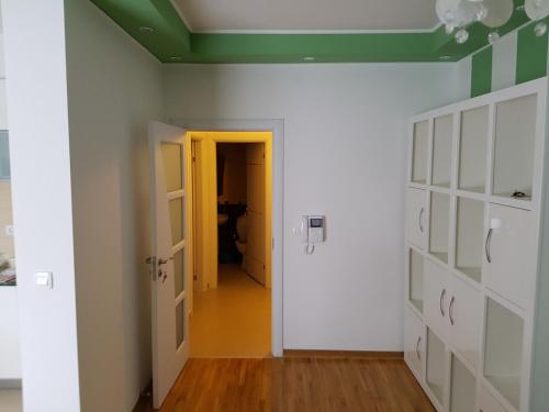 a hallway with white walls and a green ceiling at Bozovic in Becici