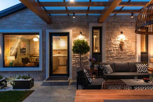 a patio with a couch and a stone wall at Villa Villetta in Novigrad Istria