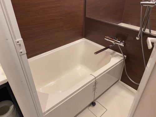 a white bath tub in a small bathroom at THREE in Tokyo