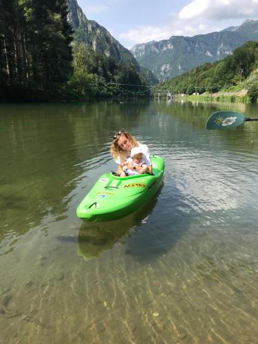 a woman holding a baby on a raft in the water at Bed & Breakfast Casa Marinella in Lenna