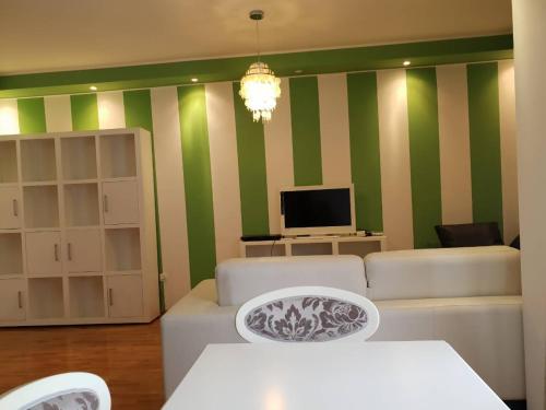 a living room with green and white striped walls at Bozovic in Becici