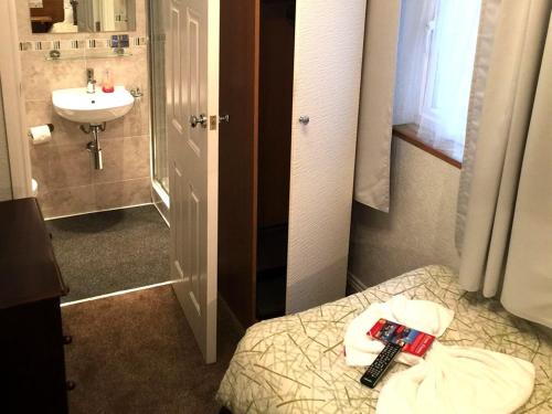 a small bathroom with a bed and a sink at Charlotte Guest House in London