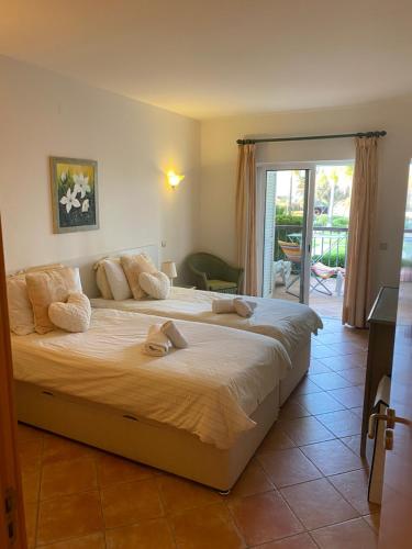 a bedroom with a large bed with towels on it at One Bedroom Apartment in Clube Alvor Ria with Beautiful View in Alvor