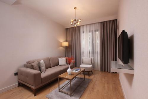 a living room with a couch and a table at The Pearl Suites in Istanbul