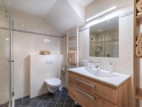 a bathroom with a sink and a toilet and a shower at Appartement Ortner in Westendorf