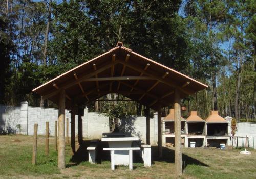 a pavilion with a bench in a park at Apartamentos Turísticos San Breixo in Carballo