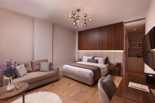 A bed or beds in a room at The Pearl Suites