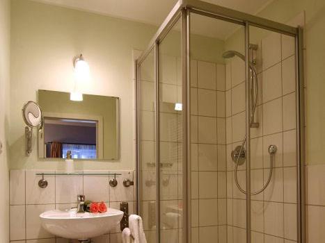 a bathroom with a shower and a sink and a mirror at Ferienwohnungen Brigitte in der Altstadt in Bad Reichenhall