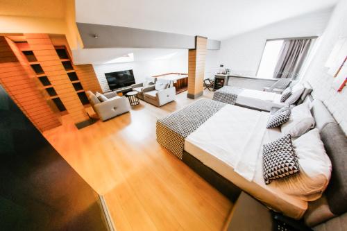 a bedroom with a large bed and a living room at Laren Family Hotel & Spa - Boutique Class in Antalya