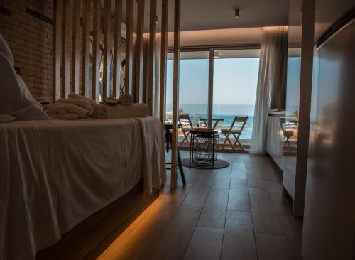 a bedroom with a bed with a view of the ocean at COSea Living: SeaSide Luxury Suite in Harbour 107A in Paphos City
