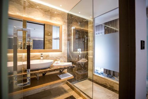 a bathroom with a sink and a shower at A Hoteli - Hotel Park in Vrnjačka Banja